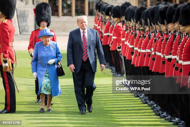 President Donald Trump and Britain's Queen Elizabeth II inspect a Guard of Honour, formed of the Coldstream Guards at Windsor Castle on July 13, 2018...