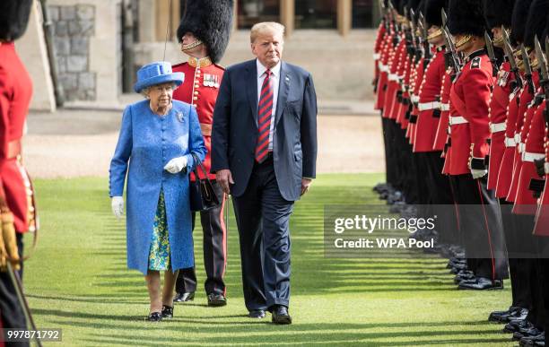 President Donald Trump and Britain's Queen Elizabeth II inspect a Guard of Honour, formed of the Coldstream Guards at Windsor Castle on July 13, 2018...