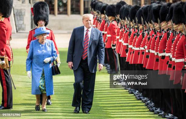 President Donald Trump and Britain's Queen Elizabeth II inspect a Guard of Honour, formed of the Coldstream Guards at Windsor Castle on July 13, 2018...