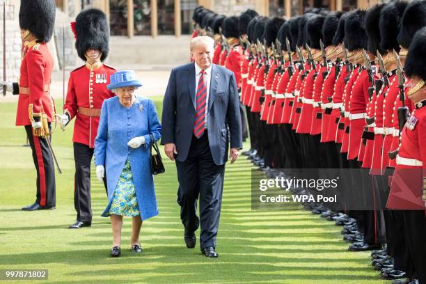 President Donald Trump and Britain's Queen Elizabeth II inspect a Guard of Honour, formed of the Coldstream Guards at Windsor Castle on July 13, 2018...
