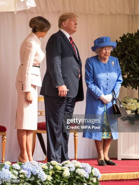 President Donald Trump and first lady Melania Trump stand with Britain's Queen Elizabeth II on the dais in the Quadrangle of Windsor Castle on July...