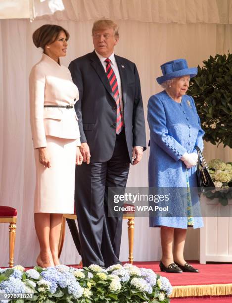 President Donald Trump and first lady Melania Trump stand with Britain's Queen Elizabeth II on the dais in the Quadrangle of Windsor Castle on July...