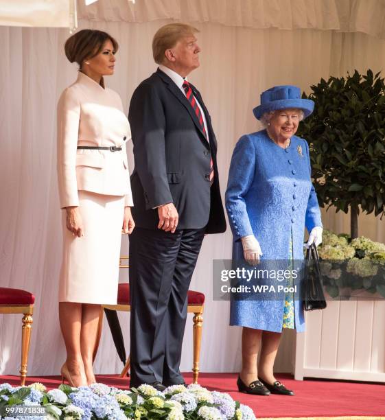 President Donald Trump and first lady Melania Trump stand with Britain's Queen Elizabeth II on the dais in the Quadrangle of Windsor Castle on July...