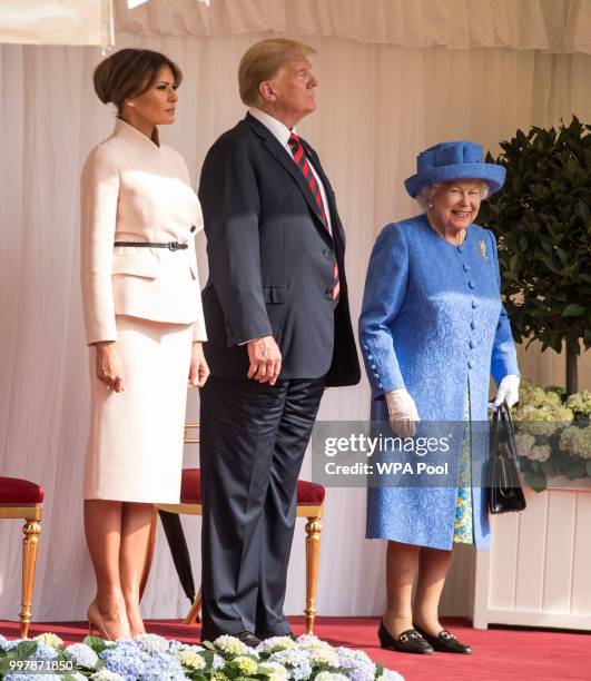 President Donald Trump and first lady Melania Trump stand with Britain's Queen Elizabeth II on the dais in the Quadrangle of Windsor Castle on July...