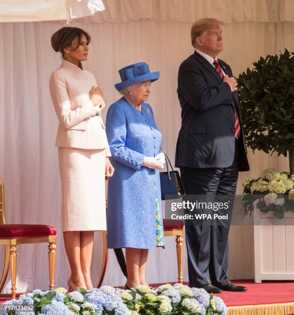 President Donald Trump and first lady Melania Trump stand with Britain's Queen Elizabeth II on the dais in the Quadrangle of Windsor Castle on July...