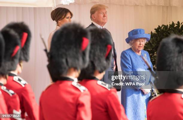 President Donald Trump, first lady Melania Trump and Britain's Queen Elizabeth II watch a Guard of Honour, formed of the Coldstream Guards march past...