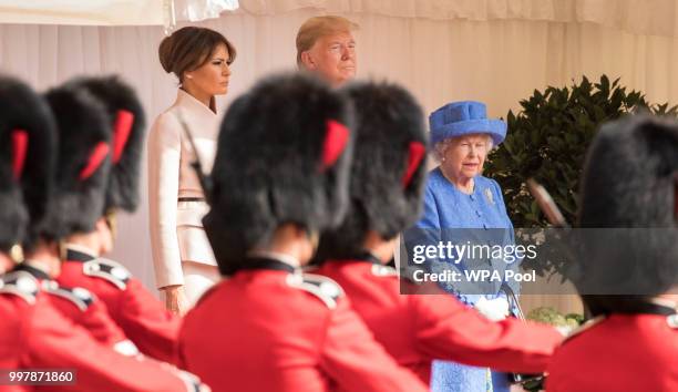 President Donald Trump, first lady Melania Trump and Britain's Queen Elizabeth II watch a Guard of Honour, formed of the Coldstream Guards march past...