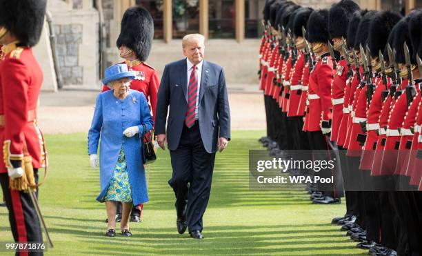 President Donald Trump and Britain's Queen Elizabeth II inspect a Guard of Honour, formed of the Coldstream Guards at Windsor Castle on July 13, 2018...