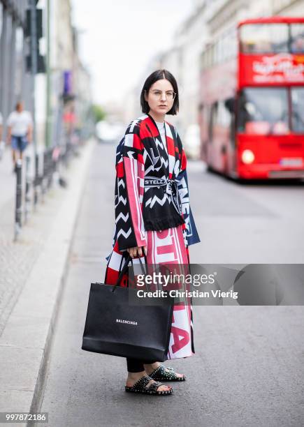 Maria Barteczko is seen wearing a patchwork knit coat Stella McCartney, black skinny jeans Acne Studios, black studded sandals Givenchy, black logo...