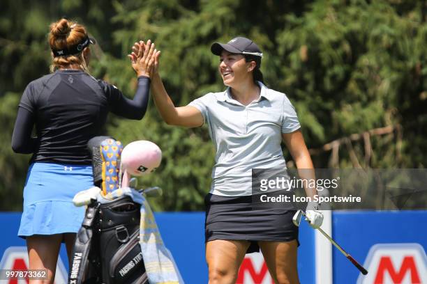 Daniela Darquea, of Ecuador, receives congratulations from playing partner Alison Lee after scoring a hole-in-one on the sixth hole during the second...