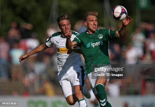 Patrick Herrmann of Moenchengladbach and Kresimir Matovina of VfB Luebeck battle for the ball during the pre-season friendly match between VfB...