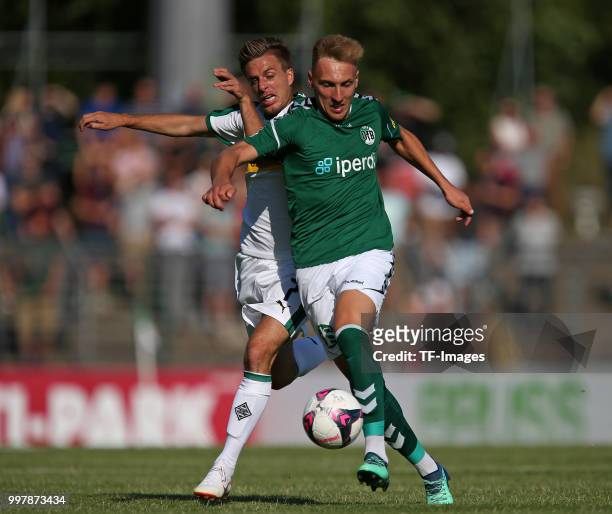 Patrick Herrmann of Moenchengladbach and Kresimir Matovina of VfB Luebeck battle for the ball during the pre-season friendly match between VfB...