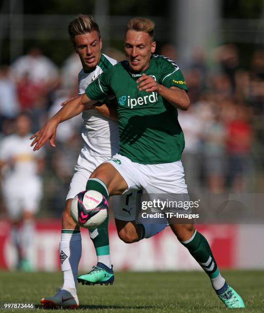 Patrick Herrmann of Moenchengladbach and Kresimir Matovina of VfB Luebeck battle for the ball during the pre-season friendly match between VfB...