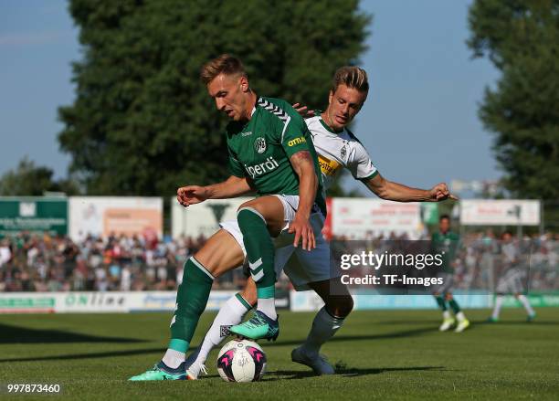 Kresimir Matovina of VfB Luebeck and Patrick Herrmann of Moenchengladbach battle for the ball during the pre-season friendly match between VfB...