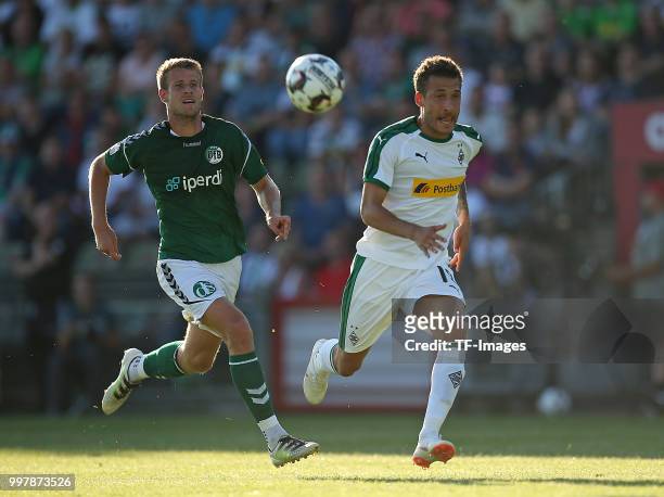 Tommy Grupe of VfB Luebeck and Fabian Johnson of Moenchengladbach battle for the ball during the pre-season friendly match between VfB Luebeck and...