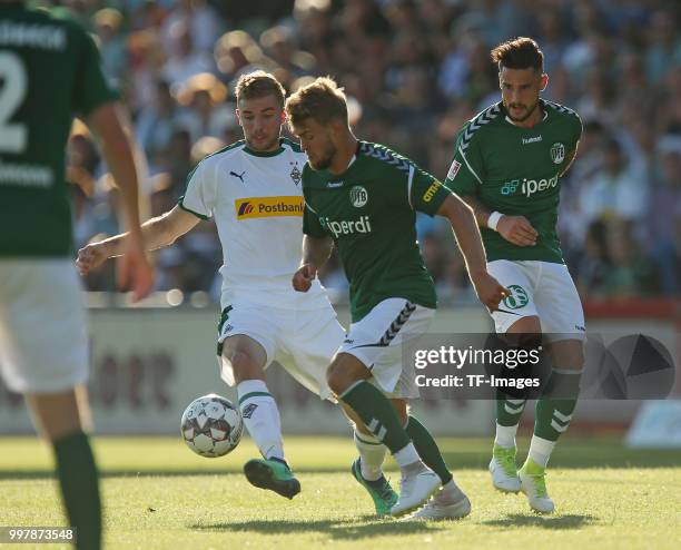 Christoph Kramer of Moenchengladbach, Yannick Deichmann of VfB Luebeck and Daniel Franziskus of VfB Luebeck battle for the ball during the pre-season...