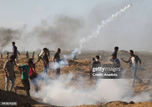 Israeli forces use tear gas to disperse Palestinian demonstrators taking part in the "Great March of Return" demonstration with ''Fidelity to Khan...