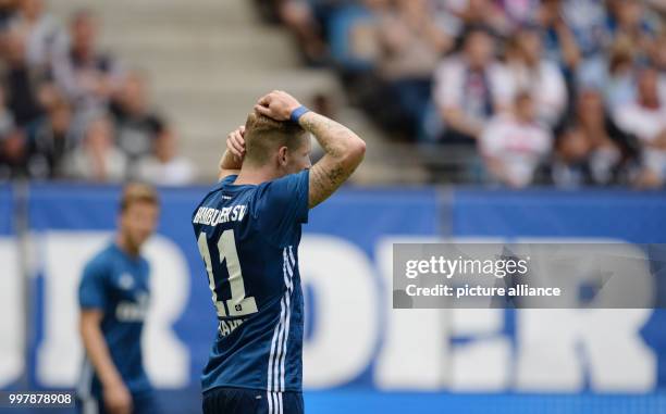 Hamburg's Andre Hahn reacts after missing a penalty during the friendly football match between Hamburg SV and Espanyol Barcelona at the...