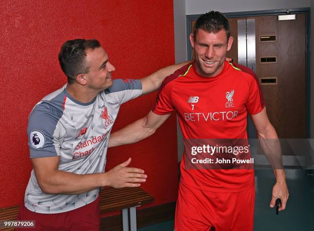 Xherdan Shaqiri with James Milner of Liverpool signs for Liverpool at Melwood Training Ground on July 13, 2018 in Liverpool, England.