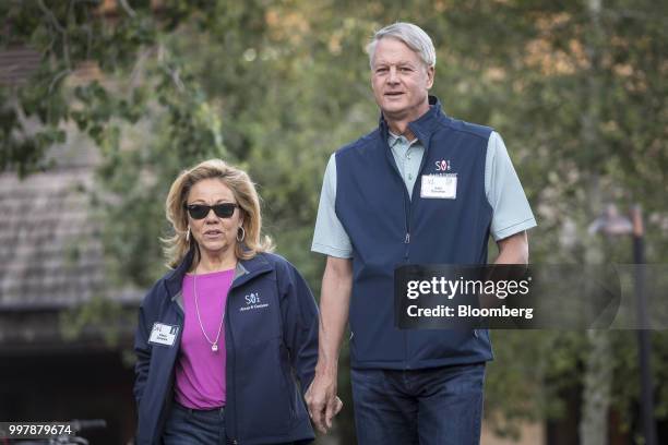 John Donahoe, president and chief executive officer of Service-Now.com Inc., right, and Eileen Donahoe arrive for a morning session at the Allen &...