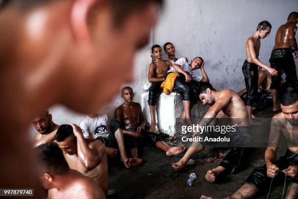 Wrestlers rest after competing on the first day of the 657th annual Kirkpinar Oil Wrestling Festival in Sarayici near Edirne, Turkey on July 13, 2018.