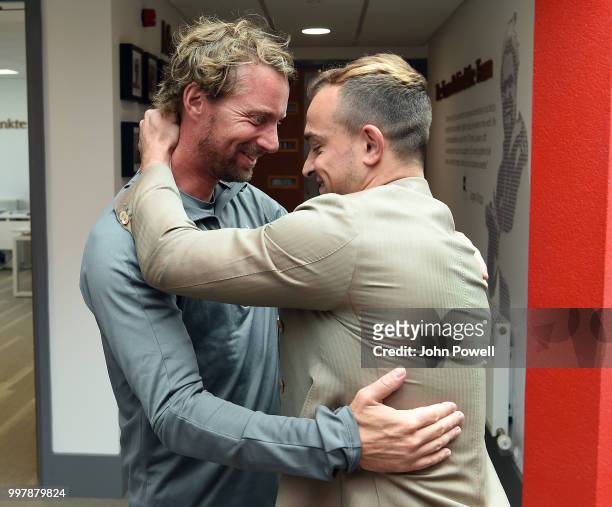 Xherdan Shaqiri with Andreas Kornmayer Head of Fitness of Liverpool before he signs for Liverpool at Melwood Training Ground on July 13, 2018 in...