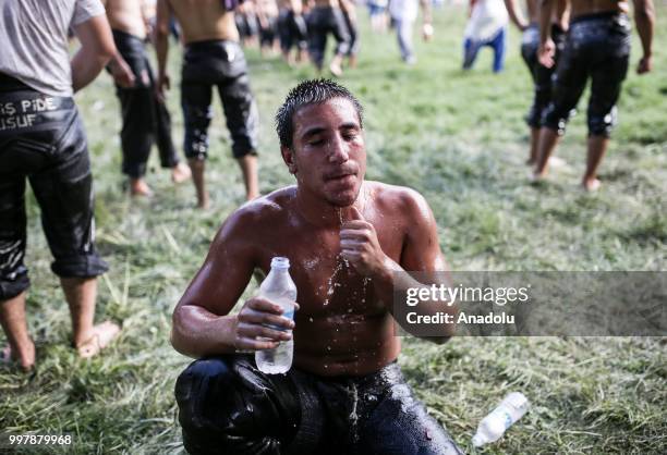 Wrestler cools off with water after competing on the first day of the 657th annual Kirkpinar Oil Wrestling Festival in Sarayici near Edirne, Turkey...