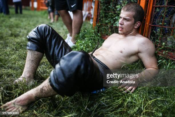 Wrestler rests after competing on the first day of the 657th annual Kirkpinar Oil Wrestling Festival in Sarayici near Edirne, Turkey on July 13, 2018.