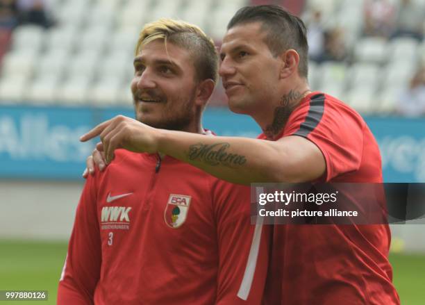 Augsburg's Konstantinos Stafylidis and Raul Bobadilla during the football friendly match between FC Augsburg and PSV Eindhoven at the WWK Arena in...