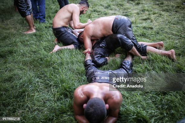 Wrestler celebrates with other wrestlers after winning against his opponent on the first day of the 657th annual Kirkpinar Oil Wrestling Festival in...