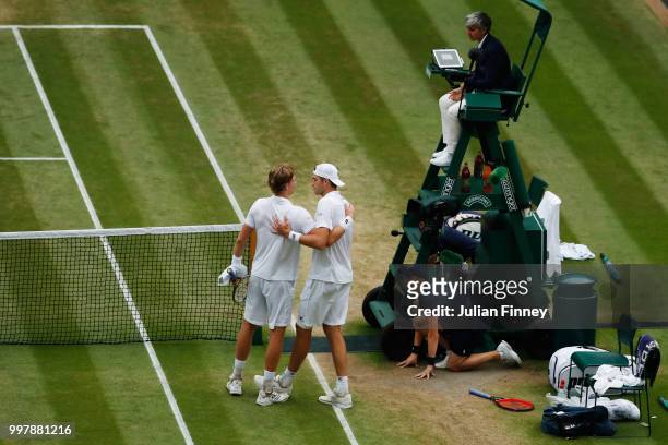 Kevin Anderson of South Africa hugs John Isner of The United States after their Men's Singles semi-final match on day eleven of the Wimbledon Lawn...