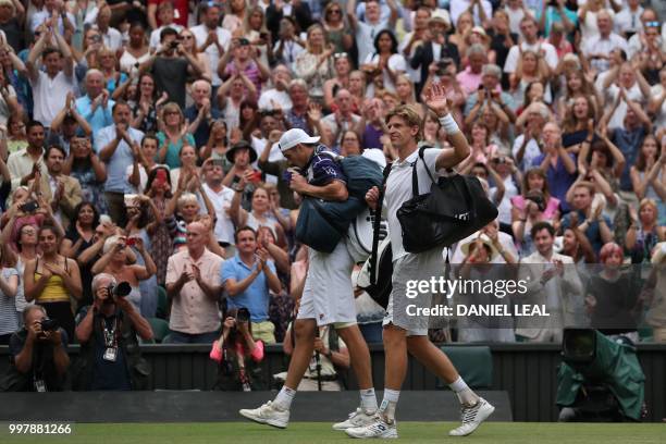 South Africa's Kevin Anderson and US player John Isner leave following the final set tie-break of their men's singles semi-final match on the...