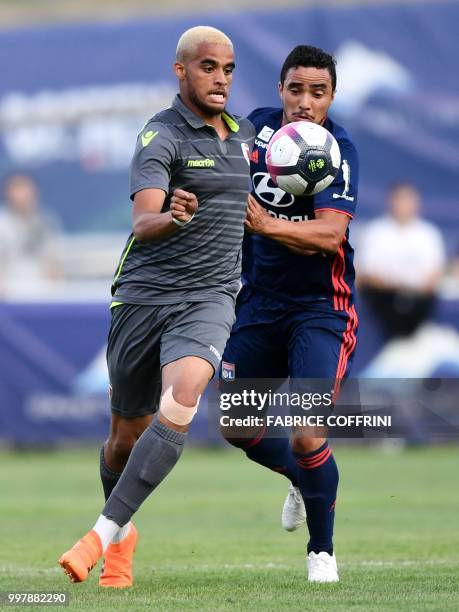 Sion's French forward Yassin Fortune and Lyon's Brazilian defender Rafael da Silva vie for the ball during the friendly football match between FC...