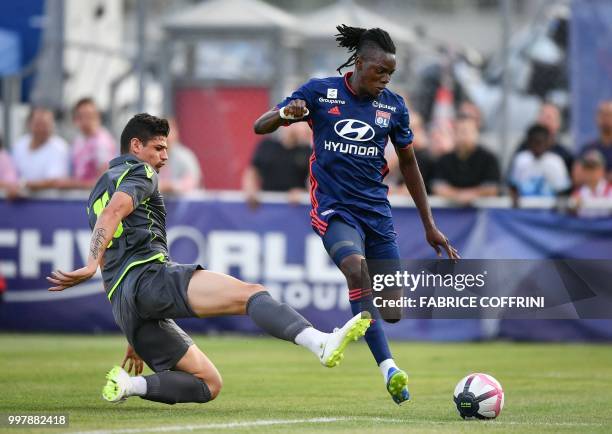 Lyon's Burkinabe forward Bertrand Traore and FC Sion's Brazilian defender Raphael vie for the ball during the friendly football match between FC Sion...