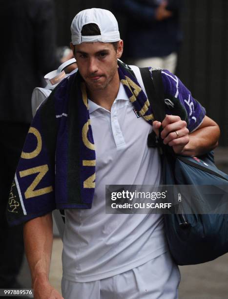 Player John Isner reacts as he leaves the court after losing to South Africa's Kevin Anderson during the final set tie-break of their men's singles...