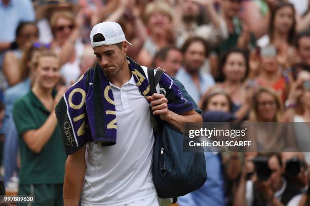 Player John Isner reacts as he leaves the court after losing to South Africa's Kevin Anderson during the final set tie-break of their men's singles...