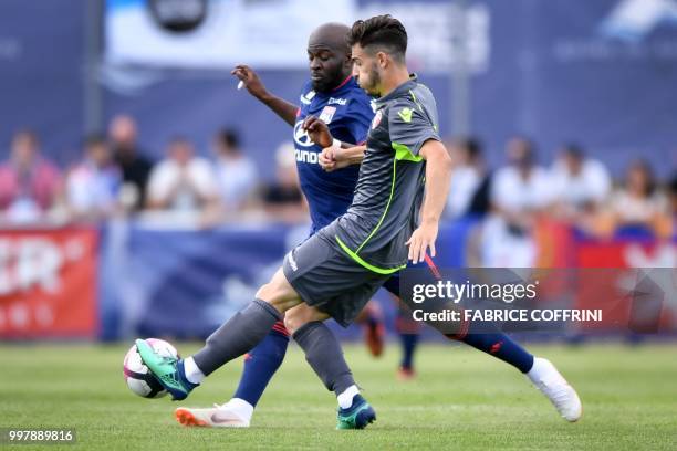 Lyon's French midfielder Tanguy Ndombele and FC Sion's Swiss midfielder Bastien Toma vie for the ball during the friendly football match between FC...