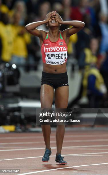 Kenyan athlete Faith Kipyegon celebrates her victory in the women's 1500 meter final event at the IAAF London 2017 World Athletics Championships in...