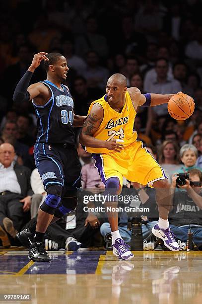 Kobe Bryant of the Los Angeles Lakers looks to move against C.J. Miles of the Utah Jazz in Game Two of the Western Conference Semifinals during the...