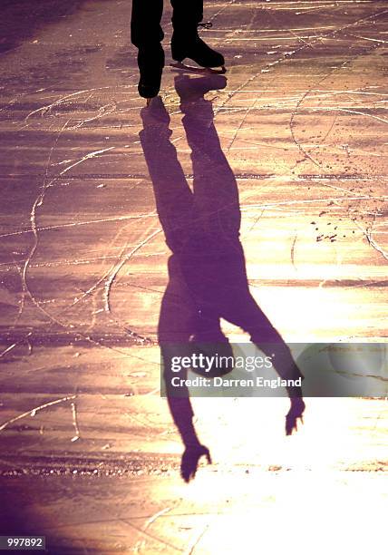 The shadow of Alexei Yagudin of Russia is reflected onto the ice as he waves to his fans after his performance at the Exhibition of Champions Figure...