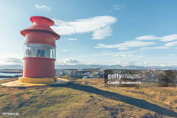 red lighthouse above stykkisholmur, iceland - red beacon stock pictures, royalty-free photos & images
