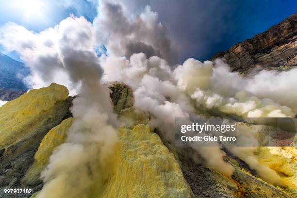 toxic vappors of sulfur mining, mount ijen crater lake, east java, indonesia - sulphur stock pictures, royalty-free photos & images