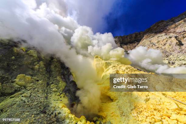 toxic vappors of sulfur mining, mount ijen crater lake, east java, indonesia - east java province stock pictures, royalty-free photos & images