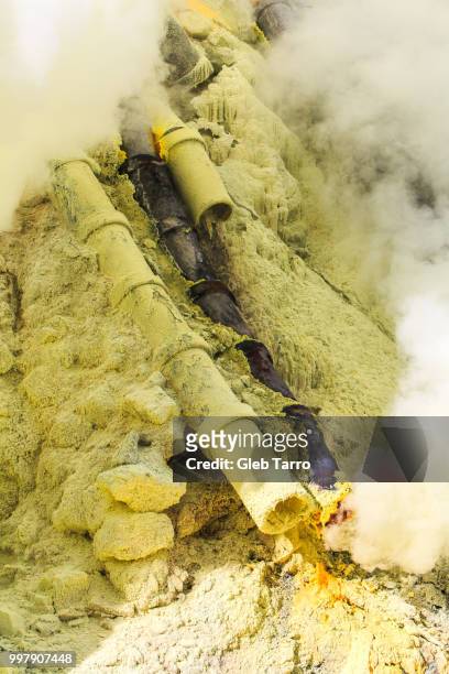 ceramic pipes for harvesting sulfur, mount ijen crater lake, east java, indonesia - east java province stock pictures, royalty-free photos & images