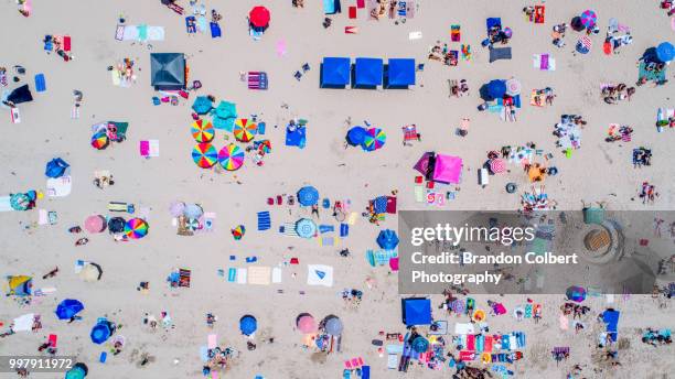 summer beach holiday - beach umbrella sand stock-fotos und bilder