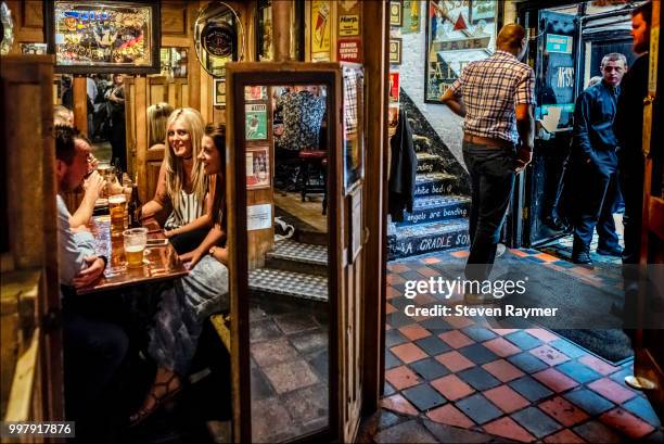 patrons sit in a snug at belfast pub - cosy pub stock pictures, royalty-free photos & images