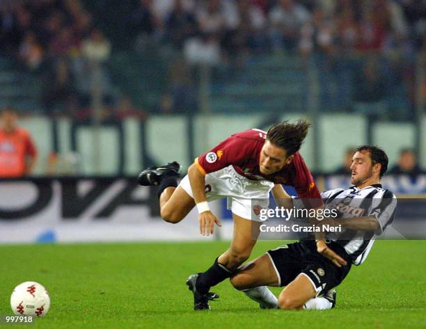 Francesco Totti of Roma is tackled by Luis Helguera of Udinese during the SERIE A 2nd Round League match between Roma and Udinese played at the...