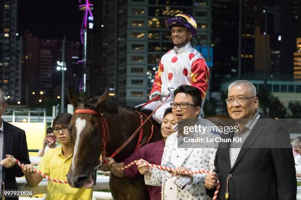 Jockey Umberto Rispoli and owners celebrate after Fantastic Fabio winning the Race 2 Bulldozer Handicap at Happy Valley Racecourse on July 11, 2018...