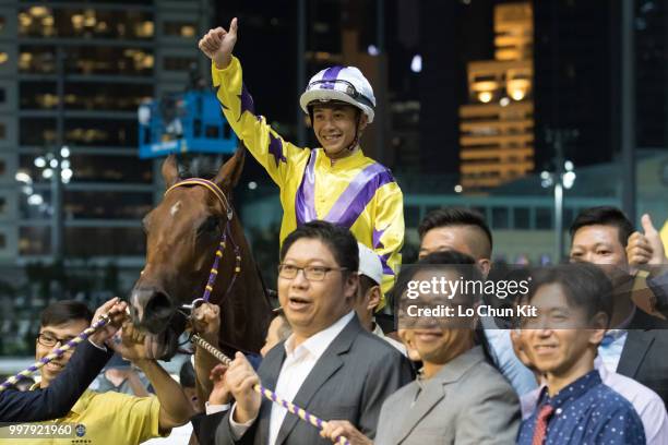 Jockey Derek Leung Ka-chun and owners celebrate after Flying Monkey winning the Race 3 Kings Falcon Handicap at Happy Valley Racecourse on July 11,...