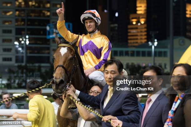 Jockey Zac Purton, trainer Michael Chang Chun-wai and owners celebrate after Saul's Special winning the Race 6 Let Me Fight Handicap at Happy Valley...